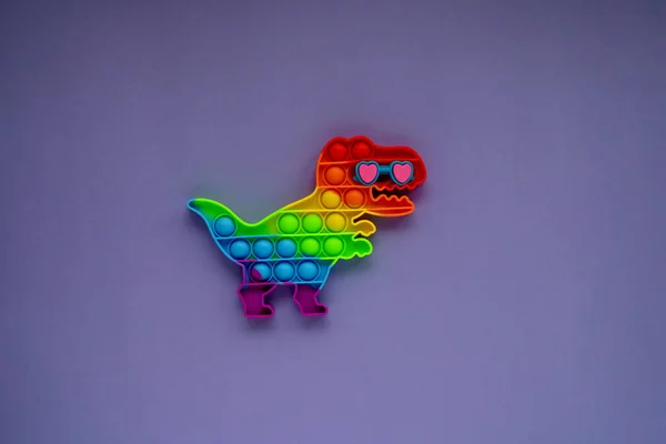Brinquedo Silicone Pop Forma Dinossauro Fundo Roxo Brinquedo Stress Para — Fotografia de Stock