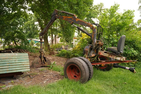 Mini excavator. Mini digger parked, excavation work outdoors.