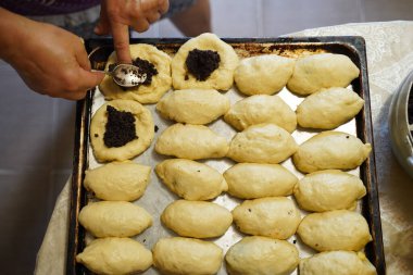 Haşhaş tohumlu turtalar. Aşçının elleri pastayı hazırlar..