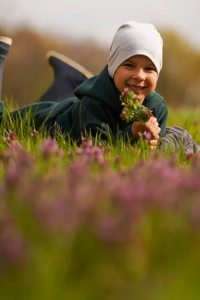 Een Gelukkig Kind Ligt Een Veld Tussen Bloemen Uitzicht Vanaf — Stockfoto