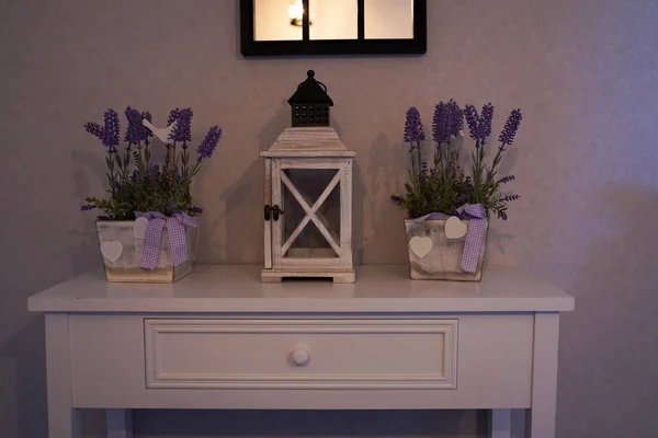 Home decor in the style of Provence, a table with a retro lantern and Lavender baskets