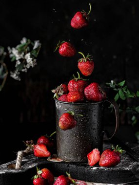 fresh strawberries on black rustic background. healthy breakfast, summer food concept.