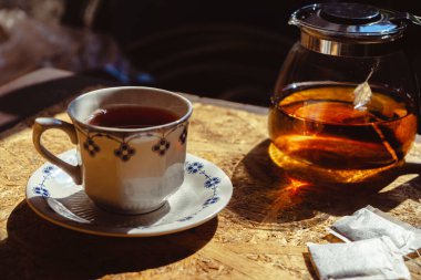 Hot tea with teapot on blur background