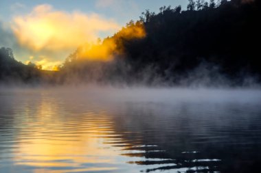 Foggy lake with sunlight. Nature abstract backgrounds wallpaper of the lake is illuminated by the sun