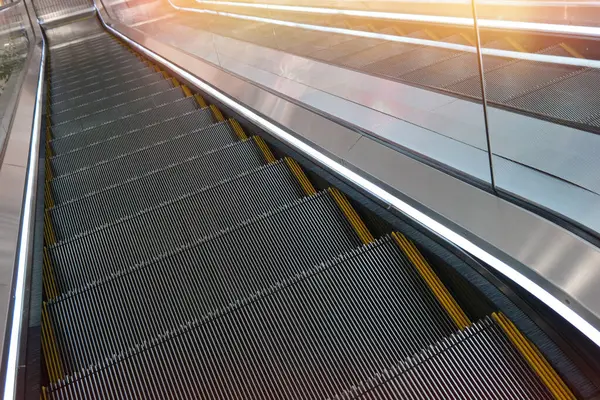 Close-up of an escalator in a modern shopping mall. Empty mall without buyers.