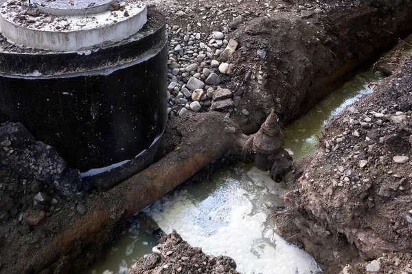 An accident in the city\'s water supply system. Trench filled with water, replacement of pipes and communications. The work of utilities to replace the water supply system in the city.