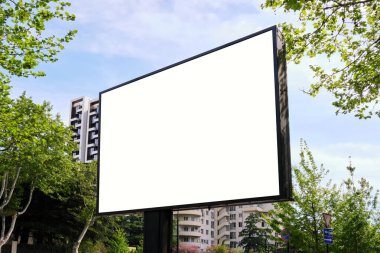 Big stand billboard on the street in the city among green trees. Template for design. clipart