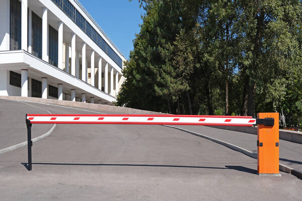 Automatic barrier at the entrance to the parking lot near the public building. Organization of safe traffic.