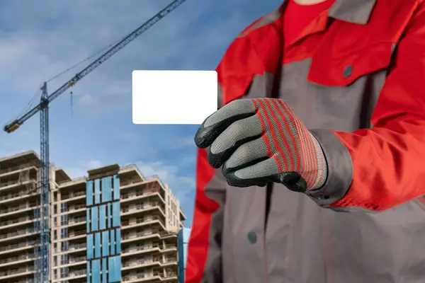Man Work Clothes Gloves Holds Blank Plastic Card His Hands lizenzfreie Stockbilder