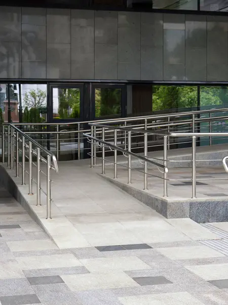 stock image Nice ramp for wheelchair users at the entrance. Installation of ramps in public places and socially significant buildings. Vertical image.