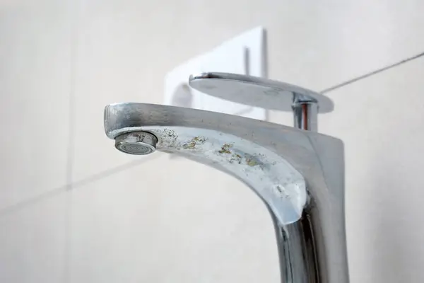 stock image Close-up of an old chrome bathroom faucet damaged by corrosion. Replacement or restoration of plumbing.