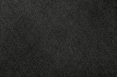 Close-up of the alcantara leather texture black color. The suede material has a beautiful marbled pile pattern reminiscent of natural velvet.