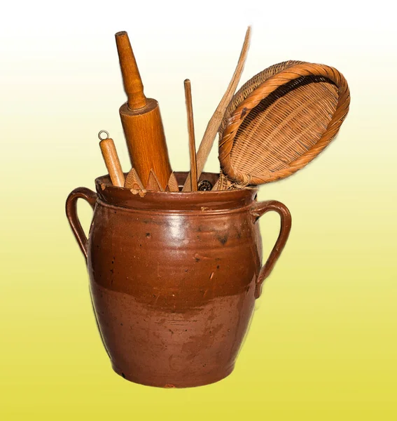 Traditional kitchen tools in a fired clay pot.