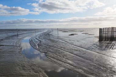 view of the access channel at low tide of the port of Andernos-les-Bains, in New Aquitaine in the south west of France