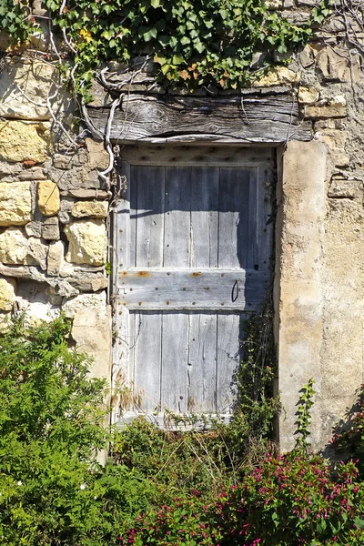 Old solid wood door of a house of Cordes sur Ciel, old medieval village elected favorite village of french, in the Tarn department in the Occitan region