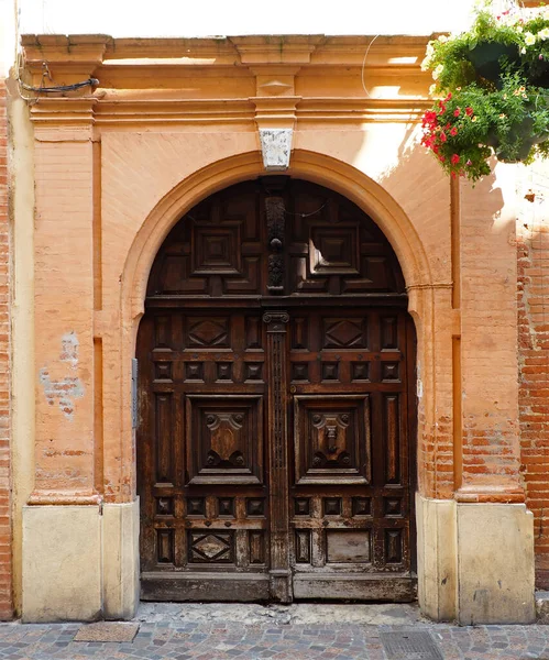 Old solid wood door of a house of Montauban, large and old French town on the banks of the Tarn, in the Tarn-et-Garonne department in the Occitan region