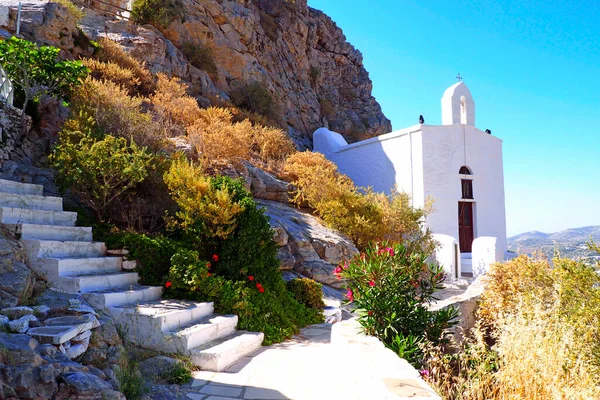one of the charms of the Cyclades islands, in the heart of the Aegean Sea are the small hidden white chapels that you discover while walking down the stairs