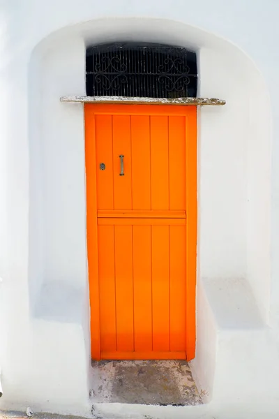 the solid old doors and windows in painted wood are one of the charms of the Cyclades, in the heart of the Aegean Sea, here in Tinos in the famous white village of the marble craftsmen of Pyrgos