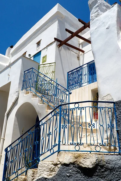 One of the charms of the Greek islands of the Cyclades archipelago (here, in Tripotamos on the island of Tinos in Greece), in the heart of the Aegean Sea, are the narrow streets: white houses, small balconies with flowers and cobblestone stairs