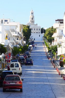 In the Cyclades archipelago, in the heart of the Aegean Sea, the main street of the town of Tinos is dominated by the church of Panagia Evangelistria to which pilgrims access by climbing on their knees clipart