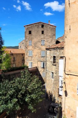 One of the charms of Sartene, a town in Corsica (nicknamed the Island of Beauty), in the heart of the Mediterranean Sea, is its narrow streets: stone houses with laundry drying in the windows and cobbled staircases clipart