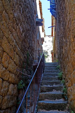 One of the charms of Sartene, a town in Corsica (nicknamed the Island of Beauty), in the heart of the Mediterranean Sea, is its narrow streets: stone houses with laundry drying in the windows and cobbled staircases clipart