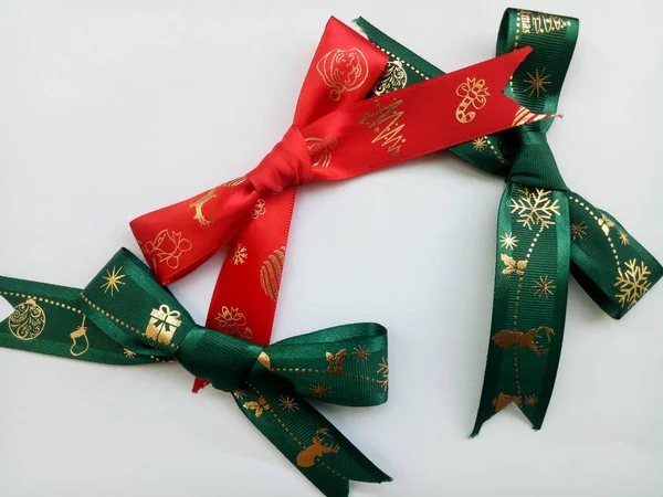 Red and green ribbon bows isolated on white background