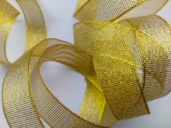 Shiny golden ornament on a white background