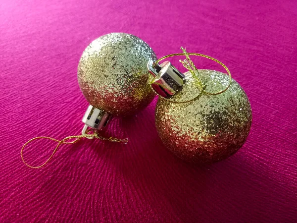 Shiny Christmas baubles isolated on textured background