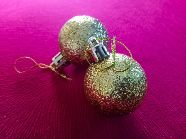 Shiny Christmas baubles isolated on textured background