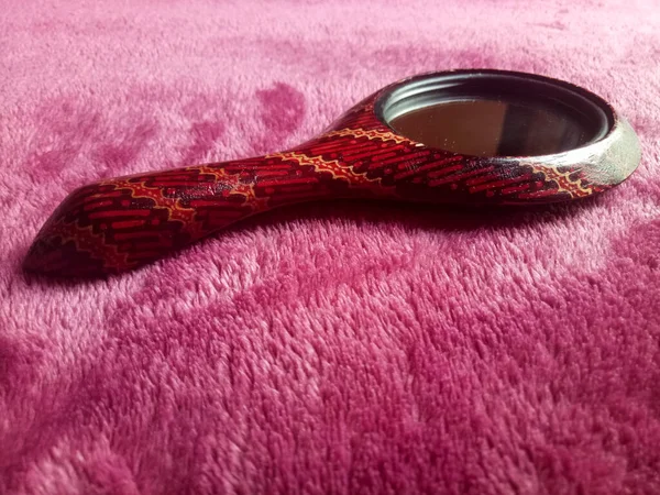 Mirror with batik pattern on a textured background