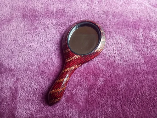 Mirror with batik pattern on a textured background