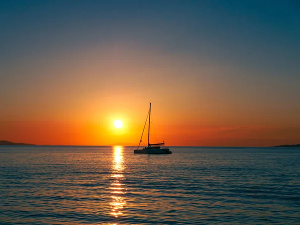 Sunset seen from the shore in Santorini, Greece. 