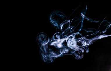 Smoke on an isolated black background. Studio macro photography. Close-up .
