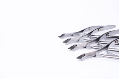 Manicure tool. Set of cuticle nippers and scissors on an isolated white background. Place for text.