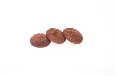 Three cookies partially covered with icing on a clean white isolated background.