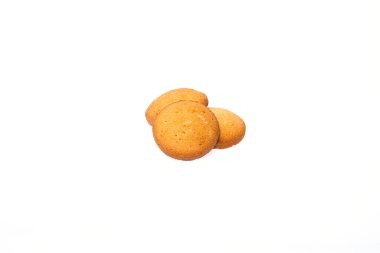 Three cookies partially covered with icing on a clean white isolated background.