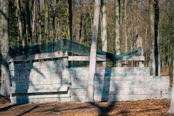 Shelter behind a wooden wall - a bunker in the paintball arena, a hideout and a field for shooting colored paint balls