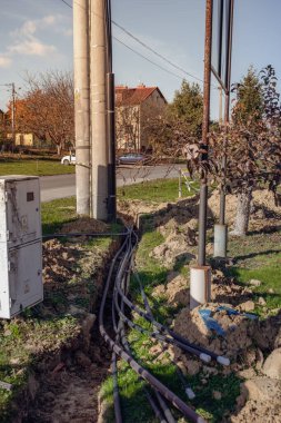 Thick power cable in the ground - electrical tunnel at the high voltage pole
