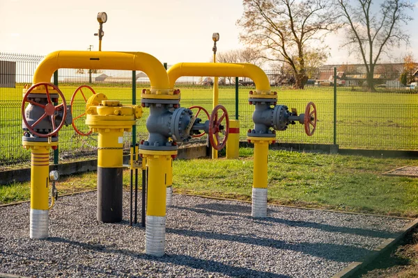 Gas pipes, natural gas transport system. Transmission infrastructure coming from the ground, yellow pipes with valve and flow meter
