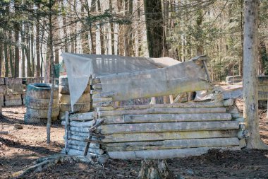 Shelter behind a wooden wall - a bunker in the paintball arena, a hideout and a field for shooting colored paint balls