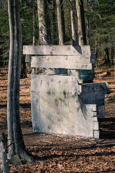 Shelter behind a wooden wall - a bunker in the paintball arena, a hideout and a field for shooting colored paint balls