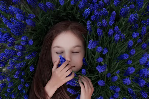 그녀의 주위에 파란색 잔디에 머리를 여자의 초상화 클로즈업 상단보기 여름의 스톡 사진