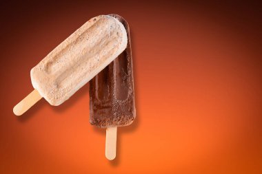 Peanut and chocolate popsicle with orange gradient background.