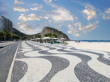 Copacabana Sahili 'ndeki ünlü sahil yürüyüşü ve Rio de Janeiro Brezilya' da mavi gökyüzü olan hindistan cevizi ağaçları..