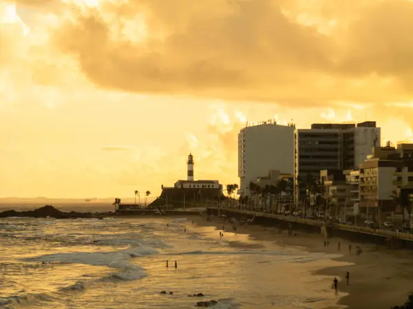 stock image Sunset at Barra beach in Salvador Bahia with Barra Lighthouse in the background.