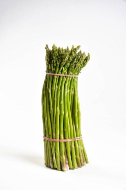 Bunch of wild asparagus on a white background clipart