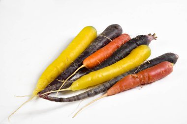 Some varieties of colorful carrots on a white background clipart