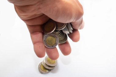 Hand holding egyptian coins isolated on a white background
