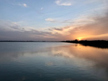 A Lake in a Horizon and Playfull Clouds